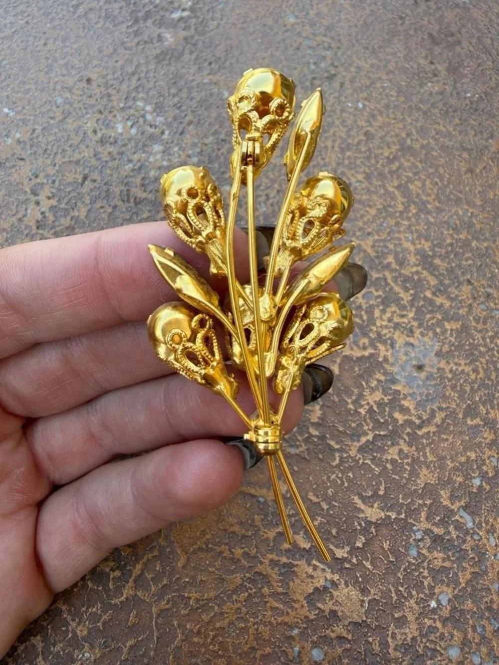 Vintage 1960s brooch with gold-tone metal and light green and orange rhinestones